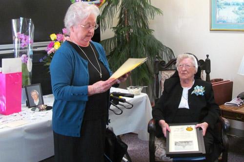 Sister Chabanel Finnegan, RSM, reads greetings from Gov. Mike Beebe and President Barack Obama to Sister Mary Reginald Mooney, RSM, at a Jan. 6 party for her 100th birthday at McAuley Convent in Barling