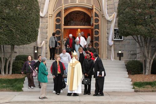 Bishop Taylor greets congregants outside the Cathedral of St. Andrew in Little Rock following Mass. Photo by Malea Hargett