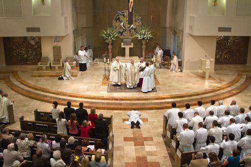 During the Litany of Supplication, Father George Sanders lays prostrate before the altar at Christ the King Church in Little Rock during his ordination Mass. Also on the front rows were most of the 41 seminarians who are preparing to return to school later this month. Bob Ocken photo