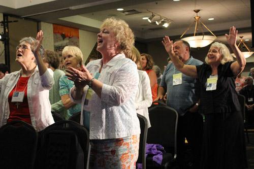 Laurie Flanagan (left) and Christy Miller, both of Hot Springs, and Kathy Clayton of Saginaw, Mo., dance and sing.