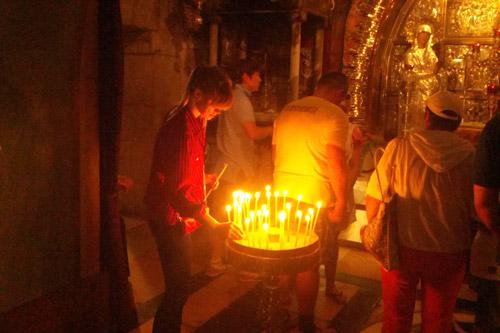 Hebda lights a candle at the Church of the Holy Sepulchre in Jerusalem, site of the crucifixion of Jesus.