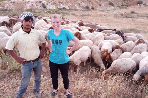 Samir, a local herdsman, grazed his animals behind the hostel where Hebda stayed. Here, they pose for a picture after she and other residents doused a small brush fire that threatened his livestock.