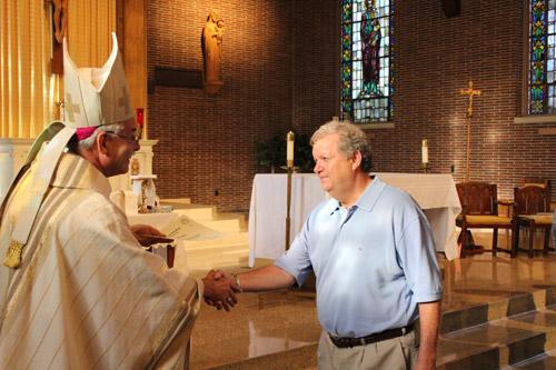 Steve Routon of St. Francis of Assisi Church in Forrest City accepts his certificate of completion from Bishop Anthony B. Taylor during graduation Mass Sept 7 in Little Rock. Dwain Hebda photo