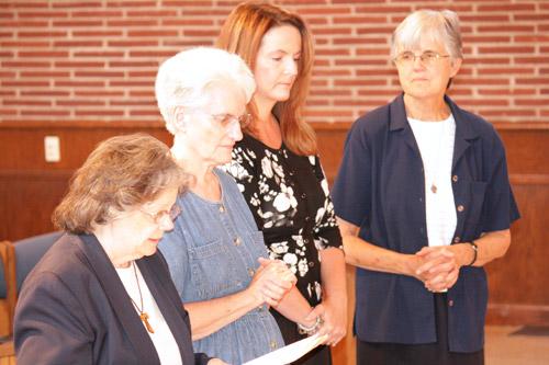 Judith Weaver reads her vows before Bishop Taylor in the presence of her sponsors, including Sister Joan Pytlik, DC. Malea Hargett photo