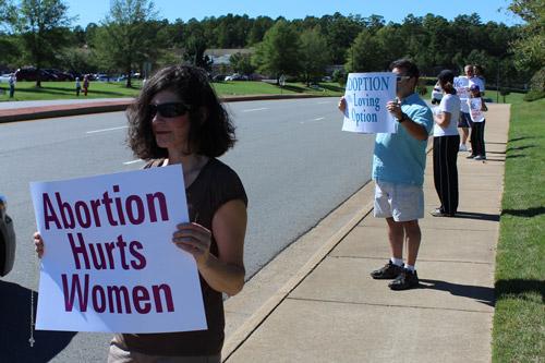 Denise Morbit, director of youth ministry at Our Lady of the Holy Souls Church in Little Rock anchors a line of pro-life witnesses along Chenal Parkway. Dwain Hebda photo