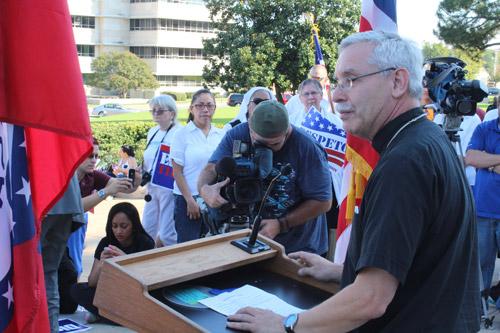 Bishop Anthony B. Taylor delivers stinging remarks from the steps of the state capitol. “National borders are at the service of the common good of both nations that share that border — not just the perceived self-interest of the more powerful of the two,” he said. Dwain Hebda photo