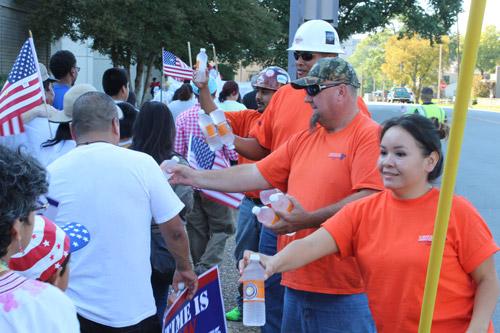 Member of the AFL-CIO set up a water station and handed out bottled water to thirsty marchers en route to the Arkansas state capitol. Dwain Hebda photo