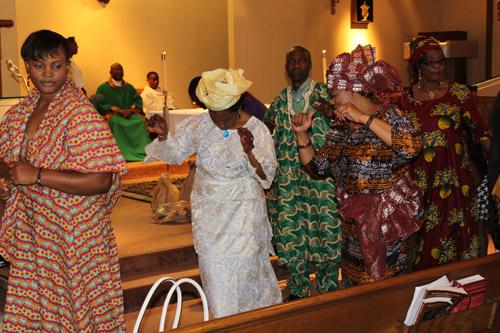 Parishioners dance their way back to their seats after leaving gifts of food and beverages at the foot of the altar. The entire Igbo congregation processed in from the back of the church during presentation of gifts. Dwain Hebda photo
