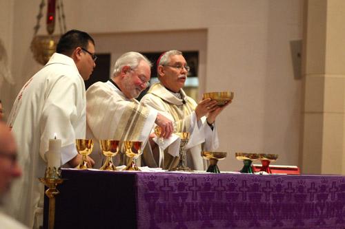 Deacon Jack Sidler Sr. assists the bishop during the Liturgy of the Eucharist.