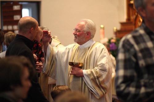 Deacon Jack Sidler blesses a child before distributing Communion.