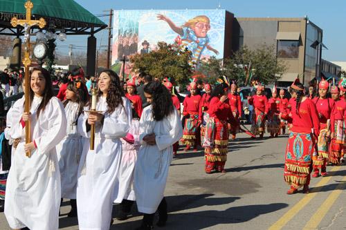Altar servers, followed by members of La Danza San Jose dance group, lead a procession Dec. 15. More than 500 Hispanic parishioners of St. Joseph Church in Conway formally observed the feast day.
