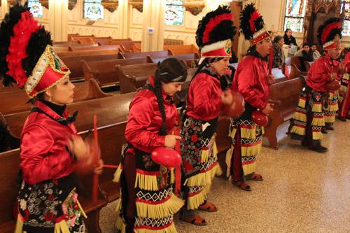 Dancers from Danza San Eduardo, a Hispanic heritage dance troop at St. Edward Church in Little Rock, performs to close the morning Mass and music there Dec. 12. Dwain Hebda photo