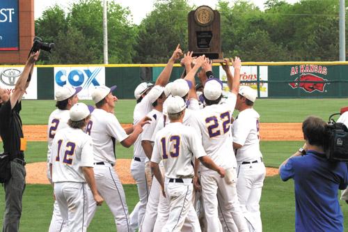 Players lift their championship trophy in celebration after St. Joseph High School in Conway defeated Dierks 13-3 May 17 for its first 2A state baseball championship.