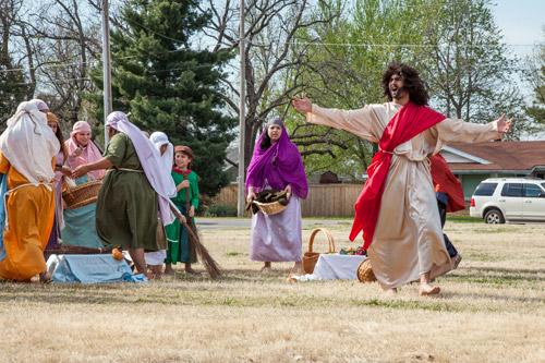 Jesus (Jesus Garcia) is upset with the vendors in the temple and destroys the booths during an outdoor theatrical presentation at St. Vincent de Paul Church in Rogers on Palm Sunday April 13. Arkansas Catholic photo by Paul Dufford