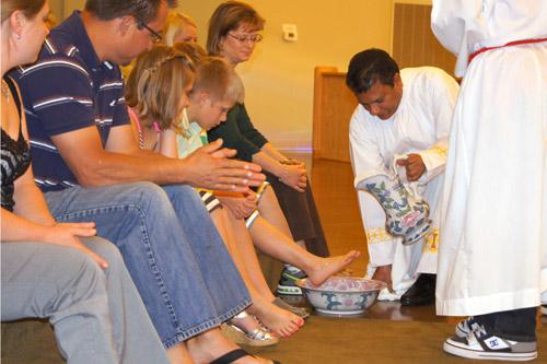 Father Mathew Malapati of St. Albert Church in Heber Springs washes the feet on Holy Thursday of several of people who were joining the Church. 