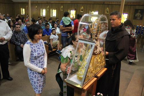 At the conclusion of Mass, parishioners were invited to come forward to venerate the statue. Dwain Hebda photo