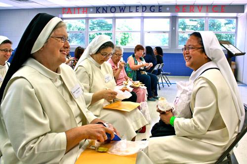 Sister Ann Marie Ferricher (left) and Novice Marie Paul Relunia, both of Holy Angels Convent in Jonesboro share lunch and a laugh during the conference. Alesia Schaefer photo