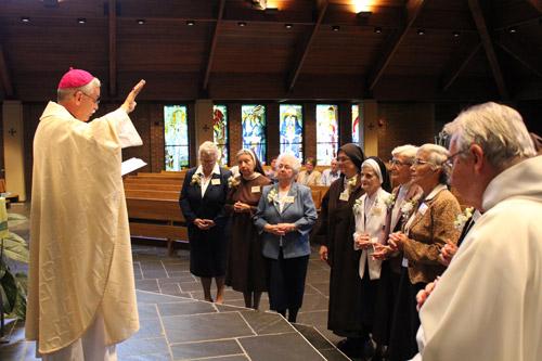 Bishop Anthony B. Taylor delivers a special blessing to the jubilarians. Collectively, the honorees represented nearly 750 years in religious life. Dwain Hebda photo