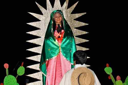 Perla Vazquez represents Our Lady of Guadalupe on a float at the 20th annual procession for the feast of Our Lady of Guadalupe for St. Vincent de Paul Parish in Rogers Dec. 11. The procession led by the local council of the Knights of Columbus included dancers, bands and floats. Afterward, singers and speakers, dancers from groups representing Mexico, a rosary and Mass were celebrated at the church. (Photo by Alesia Schaefer)