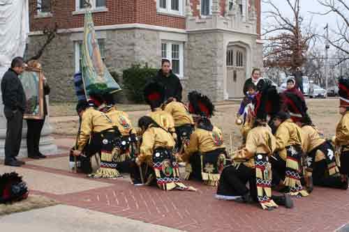 The Matachines dancers from St. Edward Church in Little Rock bow in reverence, honoring Our Lady of Guadalupe after a procession around St. John Center in Little Rock on Dec. 12. (Photo by Aprille Hanson)