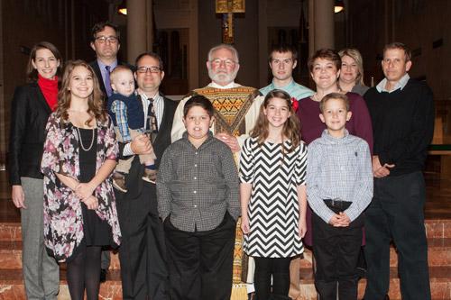 Father Jack Sidler stands with his family after his ordination at St. Benedict Church in Subiaco on Dec. 20. Father Sidler also is the only priest in the diocese who is a widower. He has three children and five grandchildren. (Karen Schwartz) 