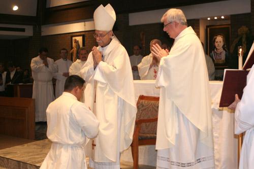 Bishop Anthony B. Taylor blesses Deacon Luis Miguel Pacheco at his diaconate ordination Mass at St. Theresa Church in Little Rock Dec. 17. (Aprille Hanson)