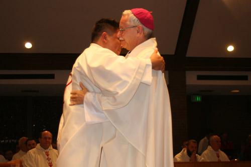 Bishop Anthony B. Taylor hugs Deacon Luis Miguel Pacheco during his diaconate ordination Mass on Dec. 17. (Aprille Hanson)