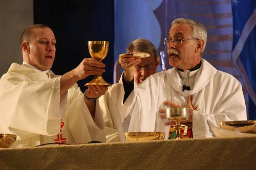 Deacon Danny Hartnedy of St. Edward Church in Little Rock holds up the chalice while Bishop Anthony B. Taylor offers prayers during the Mass for Life in the Statehouse Convention Center in Little Rock Jan. 18. (Malea Hargett)
