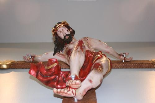 The crucifix wood carving is done in a Spanish Baroque style. In Latin America, artistic renderings of the crucifixion are more graphic. (Aprille Hanson)   