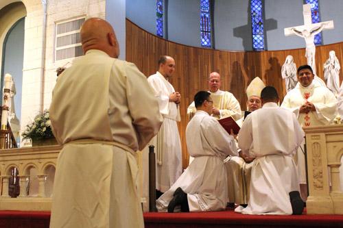 Bishop Anthony B. Taylor leads the Promise of the Elect before diaconate candidate Norman McFall. McFall is scheduled to be ordained a priest next year. (Dwain Hebda photo) 