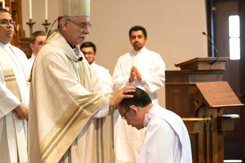 Bishop Taylor lays his hands on Deacon Joseph Chan during the Rite of Ordination.  (Karen Schwartz photo)