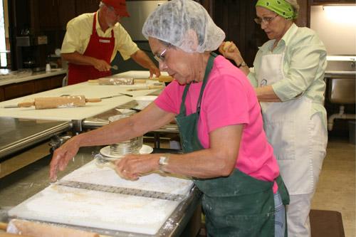 Vangie Baldwin measures the space to cut out dough for kolaches. The Slovak Bakers, at Sts. Cyril and Methodius Church in Prairie County take special orders to raise money for the Altar Society. (Aprille Hanson photo)