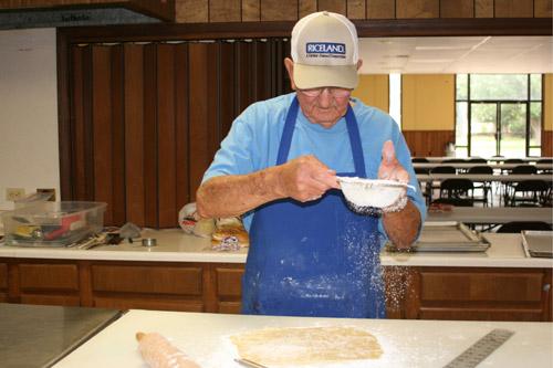 Connie Chudy sprinkles flour on his dough in preparation to make kolaches. (Aprille Hanson photo) 