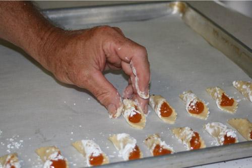 Slovak Baker Tommy Strabala places apricot filled kolaches he rolled and filled on a baking pan. The Slovak Bakers sell the apricot kolaches for $7 a dozen. 