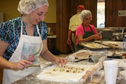 Arkansas Catholic Associate Editor Aprille Hanson is put to work making pecan-filled kolaches by the Slovak Bakers. The Slovak Bakers are open to anyone participating, no matter their level of baking experience.
