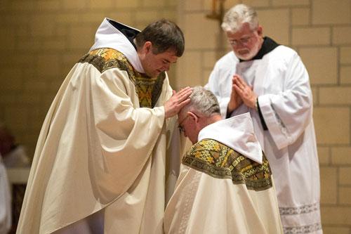 Father Patrick Boland, OSB, blesses his Abbot Leonard Wangler after the ordination Mass June 20 at Subiaco Abbey. (Karen Schwartz photo)