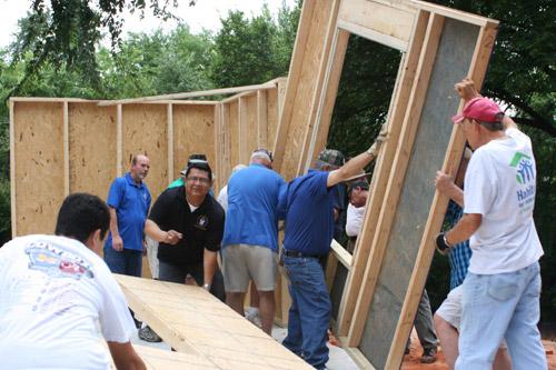 Deacon Mario Jacobo (black shirt), who will be ordained a priest next year, was helping along with other seminarians and volunteers at the Pope Francis wall raising. (Aprille Hanson) 