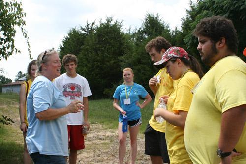 Sandy DeCoursey, St. Joseph Center of Arkansas board chairwoman, explains to the Catholic Charities Summer Institute Youth where and how to pick blackberries for St. Joseph Farm. 