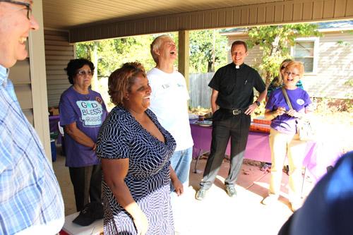 Regina Goynes, homeowner, jokes with the crowd during dedication ceremonies of the Pope Francis House. Goynes, who currently resides in a homeless shelter, said she most looked forward to being able to plant a garden at her new home. (Dwain Hebda photo)