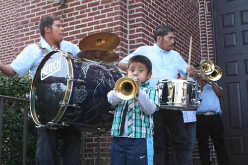 Eric Alejandre, 4, blows his trumpet as part of the Banda La Chelera, which played during the days festivities. (Aprille Hanson photo)