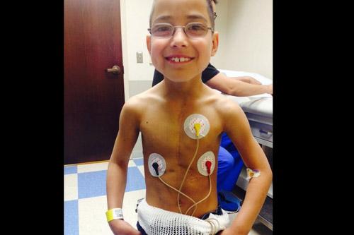 Andres Pena, who had a heart transplant as an infant, looks like any other normal, healthy 9-year-old unless he takes his shirt off. (Prints not available for this photo.)