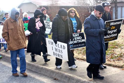 The 2.9-mile march began at St. Joseph Church and ended at the Planned Parenthood facility in Fayetteville. Father Jason Tyler (foreground) celebrated Mass before the march. (Alesia Schaefer photo)