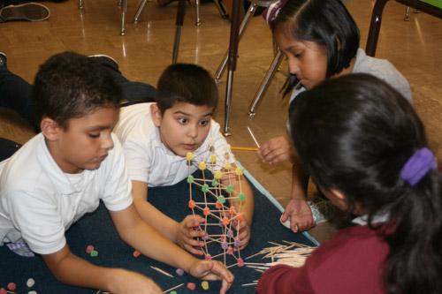 Throughout the classroom, few towers looked alike, each figuring out different shapes and ways to build it. Pictured are: Mathew Angeles, third grade (left); Jose Gutierrez, second grade; Mackenzie Delgado, third grade; and Isabela Ruiz, third grade. (Aprille Hanson photo)