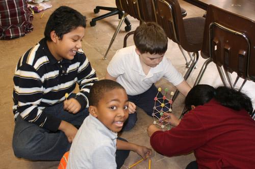 Second grader Patrick Mays flashes a smile at the camera, enjoying the latest STEM project. Others pictured are: Gabriel deLuna Vargas, third grade; Jack Moritz, fourth grade; and Isabella Martinez fourth grade. (Aprille Hanson photo)