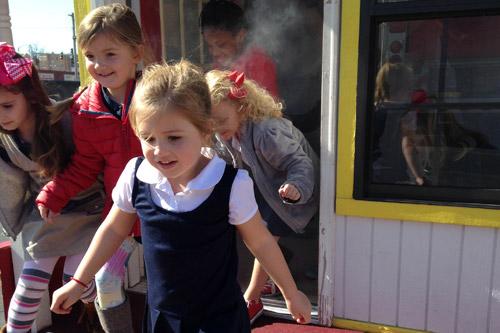 In Morrilton, Sacred Heart kindergarten students (right) learn to safely exit a smoke-filled building with the Morrilton Fire Department. On Feb. 2, students were offered a variety of mini-course activities provided in conjunction with area businesses. (Print not available for this photo.)
