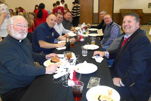 Father Jack Sidler (front left) sits with parents, staff and community leaders during the annual VIP Lunch at St. John School in Russellville to conclude Catholic Schools Week. The school also honored local police officers, priests and nuns. (Print not available for this photo.)