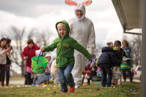 Four-year-old Anthony Piazza (at left) shares his joy during the Easter egg hunt at St. Joseph Church in Tontitown March 20. The Easter Bunny, Sharon Pianalto, also is very pleased. (Travis McAfee photo)