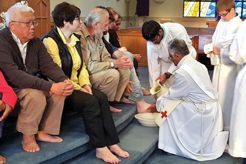 Father Felix Chirapurathel, OPraem, pastor of Immaculate Conception Church in Blytheville, washes the feet of parishioners as Jesus washed the feet of the apostles on Holy Thursday when Jesus instituted the Eucharist and the priesthood. (Prints not available)