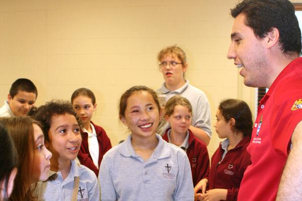Seminarian David Aguilar of Springdale (right) talks to students from St. Theresa School in Little Rock. (Malea Hargett photo)