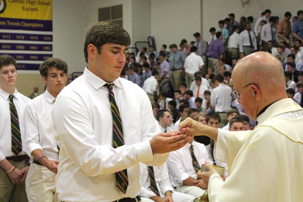 A Catholic High senior receives communion during the Ring Mass. (Dwain Hebda photo)